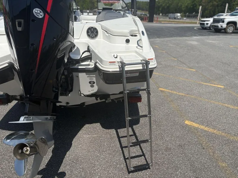 Slide: The Image of 2024 Tahoe 210 S boat with ladder and outboard motor in parking lot. - 9