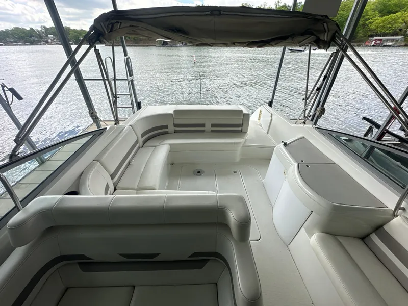 Slide: The Image of 1998 Formula 330 SunSport boat interior with spacious seating and canopy, overlooking a serene lake. - 10