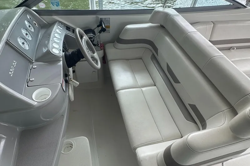 Slide: The Image of 1998 Formula 330 SunSport boat interior with steering wheel and cushioned seating. - 13
