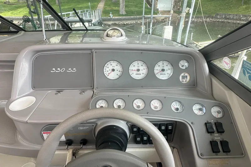 Slide: The Image of Dashboard of a 1998 Formula 330 SunSport boat with gauges and steering wheel. - 14