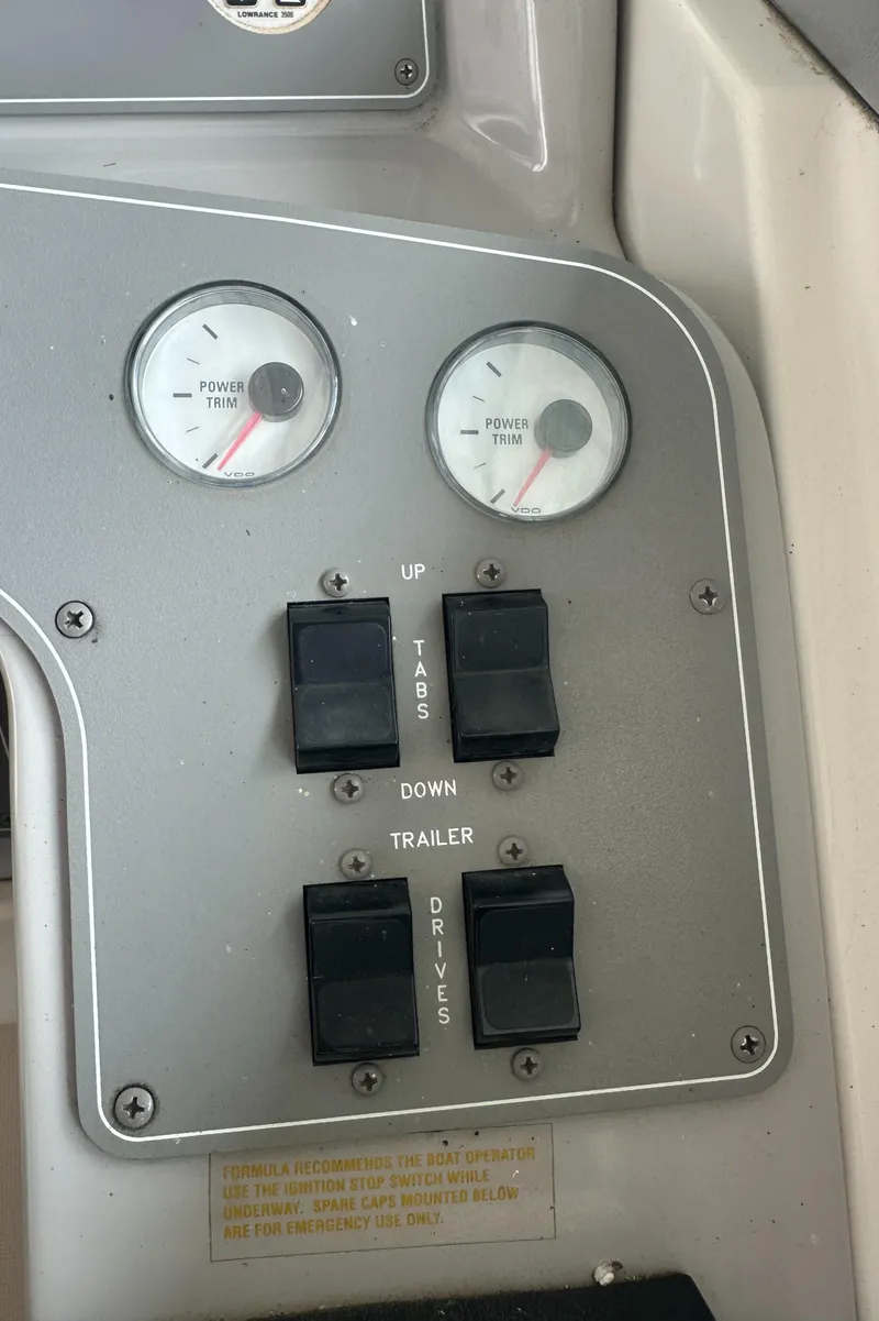 Slide: The Image of Control panel of a 1998 Formula 330 SunSport boat with gauges and switches. - 18