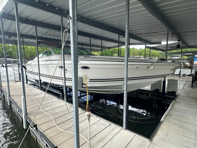 Slide: The Image of 1998 Formula 330 SunSport boat docked under a covered marina. - 2