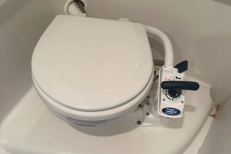 Slide: The Image of Marine toilet with Jabsco pump in a 1998 Formula 330 SunSport boat. - 25