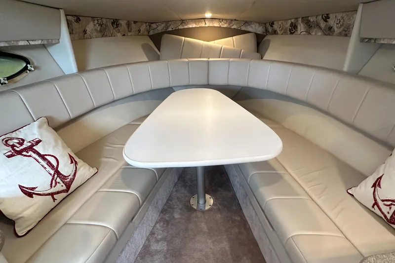 Slide: The Image of 1998 Formula 330 SunSport cabin interior with white seating and anchor-themed pillows. - 26