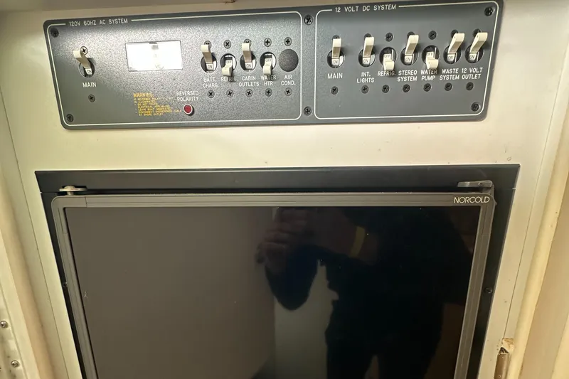 Slide: The Image of Control panel and Norcold fridge in 1998 Formula 330 SunSport boat interior. - 27