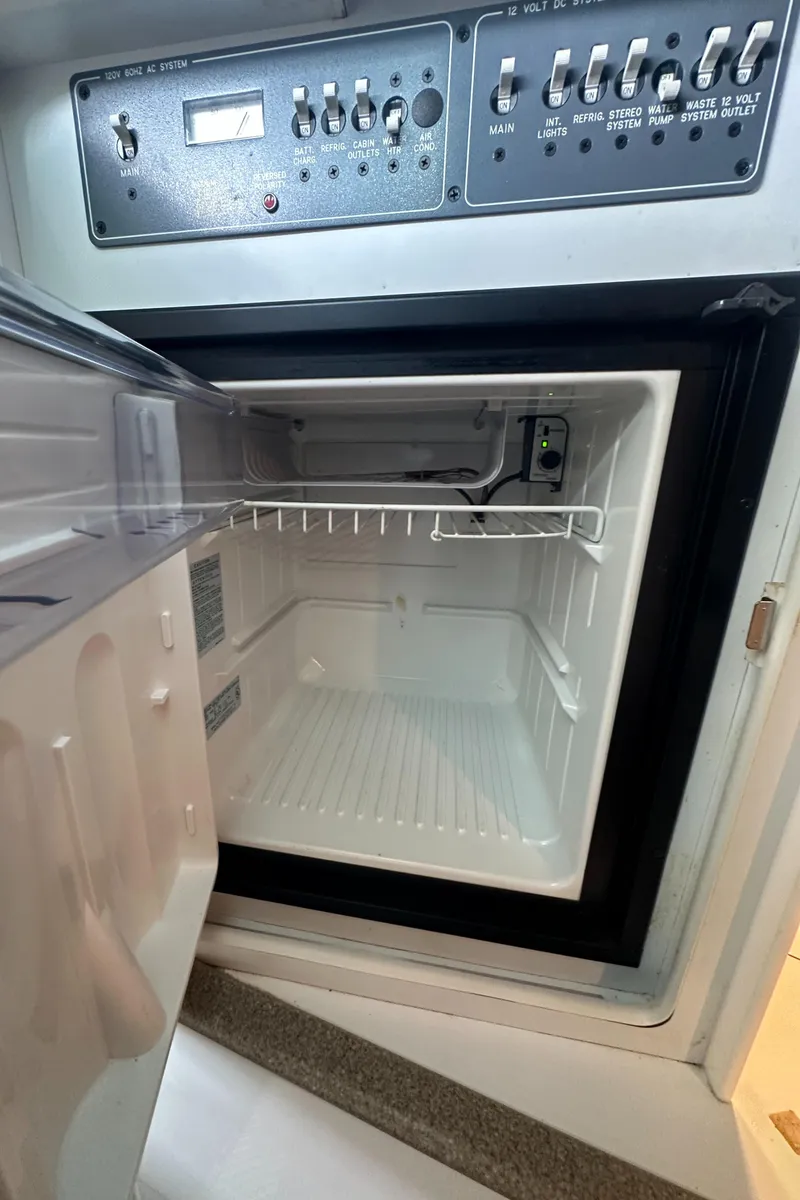 Slide: The Image of 1998 Formula 330 SunSport refrigerator with control panel, open and empty. - 28