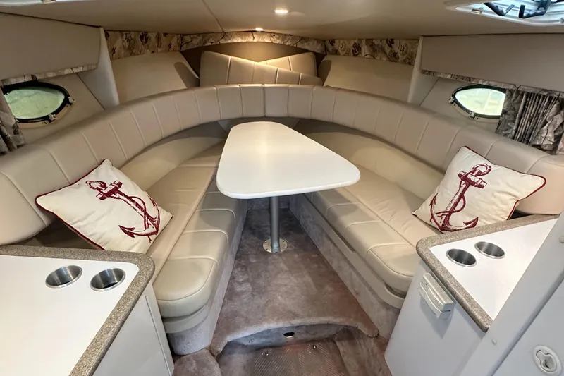 Slide: The Image of 1998 Formula 330 SunSport cabin interior with seating, table, and nautical-themed pillows. - 29