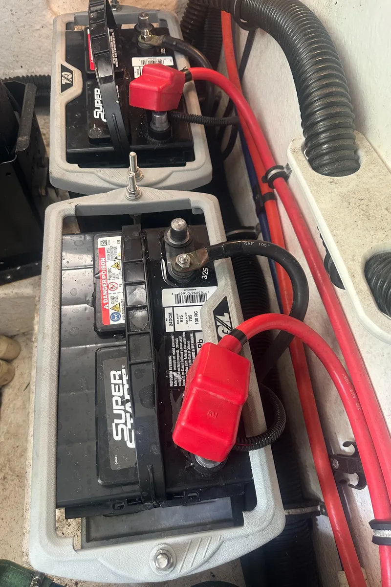 Slide: The Image of Dual marine batteries in a 1998 Formula 330 SunSport boat, connected with red and black cables. - 30