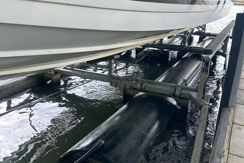 Slide: The Image of 1998 Formula 330 SunSport boat on a lift over water. - 31