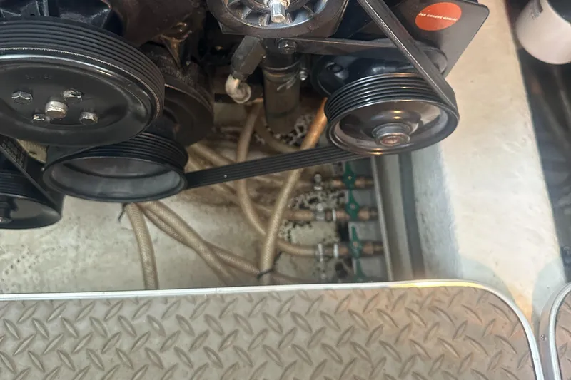 Slide: The Image of Engine compartment of a 1998 Formula 330 SunSport boat, showing belts and hoses. - 34