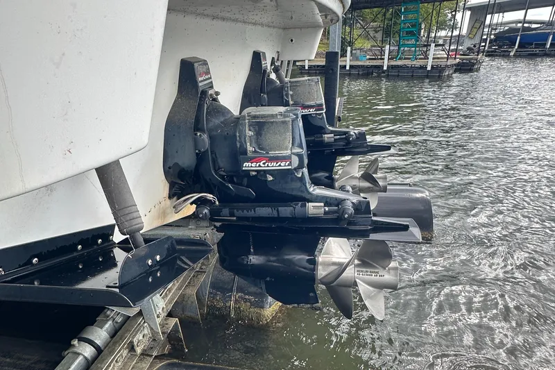 Slide: The Image of 1998 Formula 330 SunSport boat with MerCruiser outdrives docked by the water. - 38