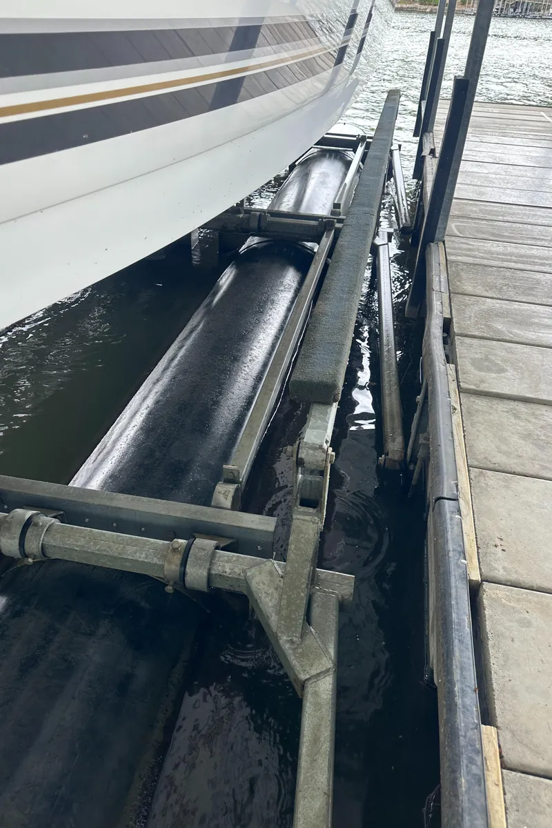 Slide: The Image of 1998 Formula 330 SunSport boat on a lift at a dockside. - 39