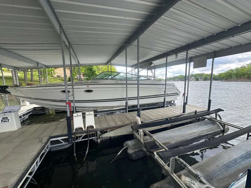 Slide: The Image of 1998 Formula 330 SunSport boat docked under a covered marina on a lake. - 6