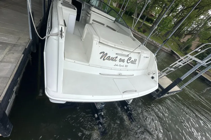 Slide: The Image of 1998 Formula 330 SunSport boat docked, rear view with "Naut on Call" name visible. - 7