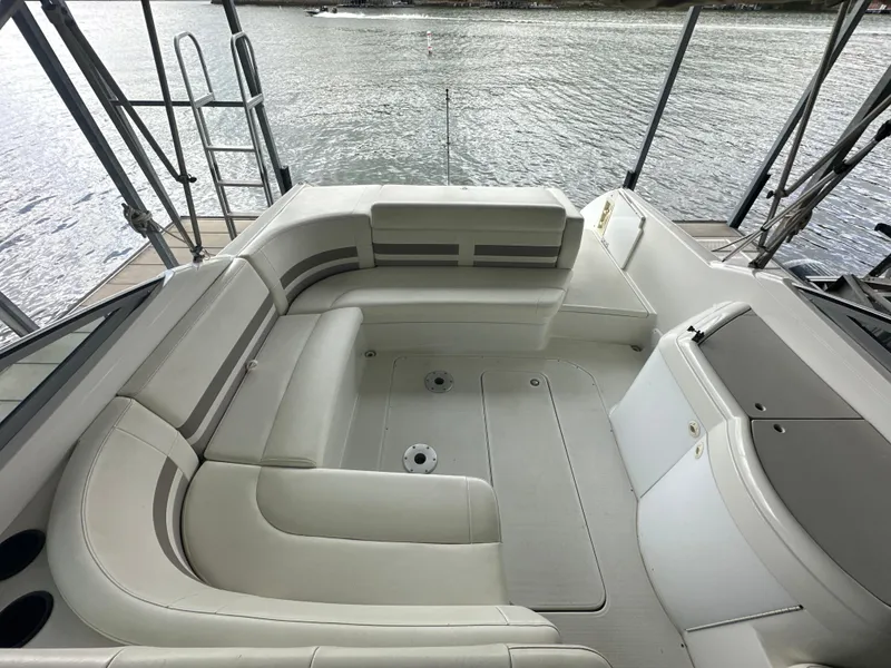 Slide: The Image of 1998 Formula 330 SunSport boat interior with white seating, overlooking water. - 9