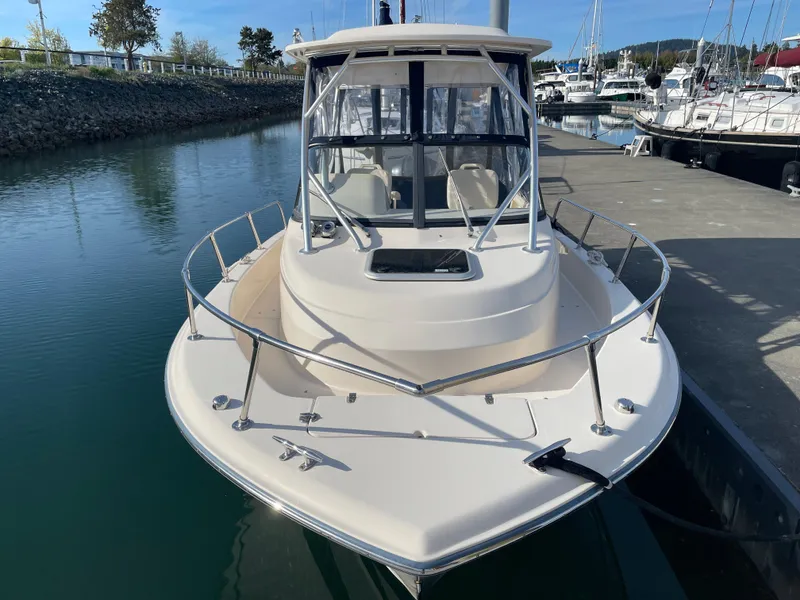 Slide: The Image of 2015 Grady-White Seafarer 226 boat docked in a marina, front view. - 2