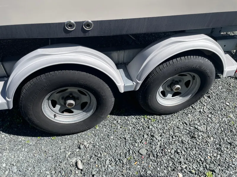 Slide: The Image of Trailer wheels of a 2015 Grady-White Seafarer 226 on gravel surface. - 22