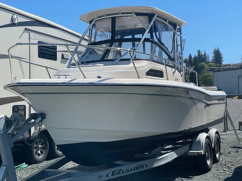 Slide: The Image of 2015 Grady-White Seafarer 226 boat on trailer, parked outdoors. - 25
