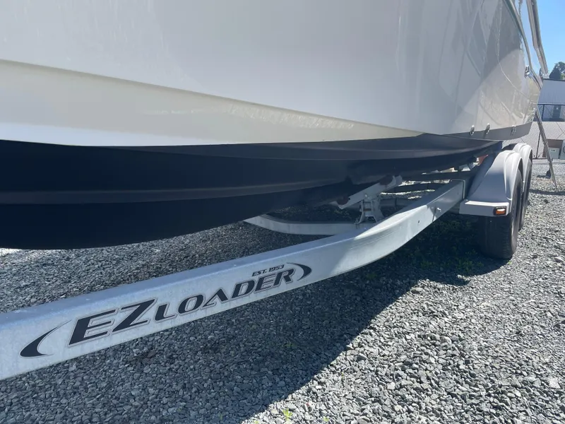 Slide: The Image of 2015 Grady-White Seafarer 226 boat on EZ Loader trailer, parked on gravel. - 27