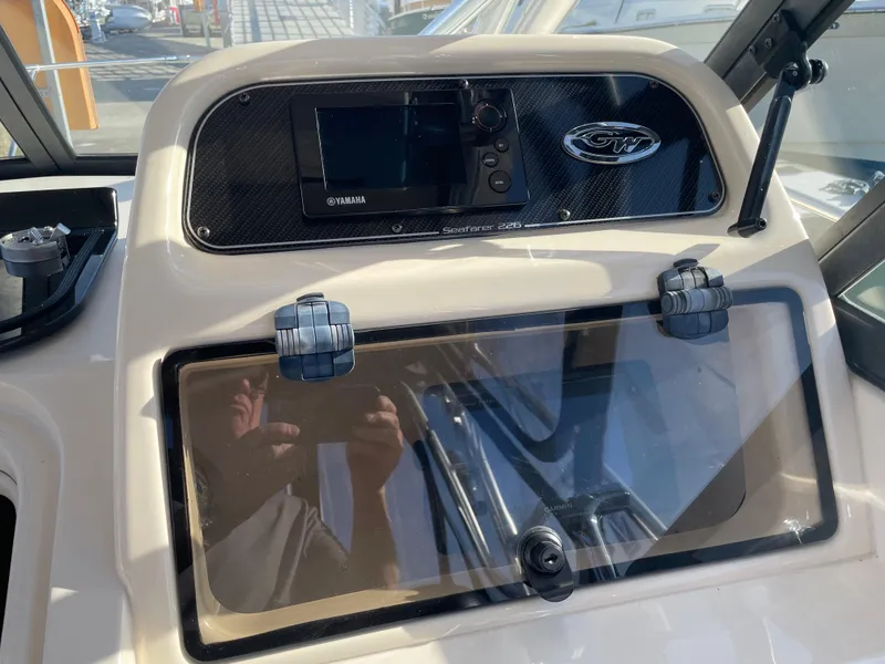 Slide: The Image of 2015 Grady-White Seafarer 226 dashboard with Yamaha electronics and storage compartment. - 9