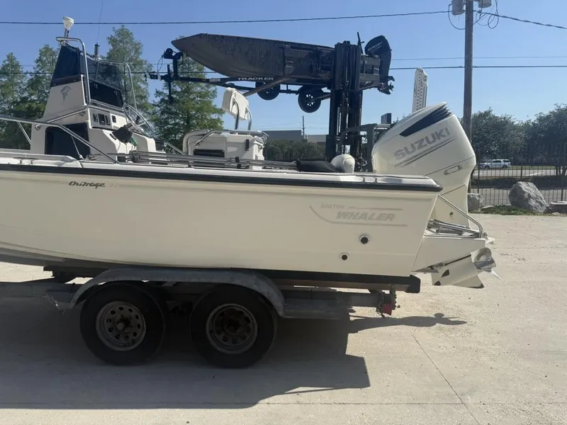 Slide: The Image of 1996 Boston Whaler 21 Outrage boat on trailer with Suzuki outboard motor. - 10