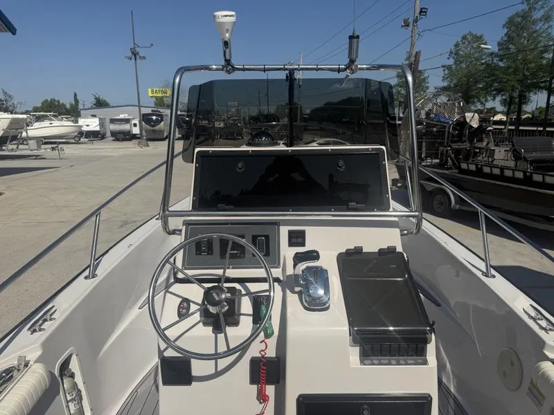 Slide: The Image of 1996 Boston Whaler 21 Outrage boat dashboard with steering wheel and controls. - 12
