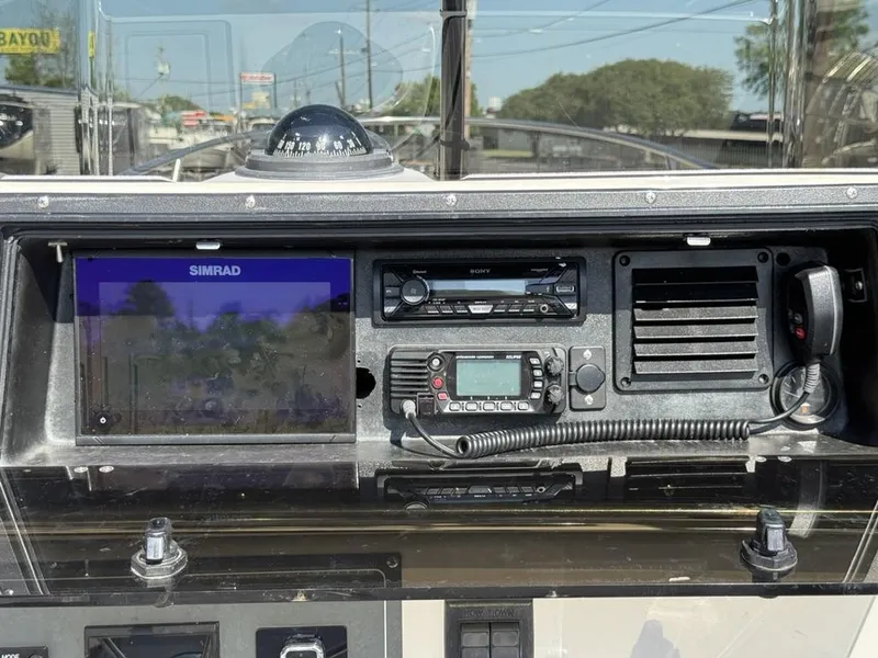 Slide: The Image of 1996 Boston Whaler 21 Outrage dashboard with Simrad display and communication equipment. - 13