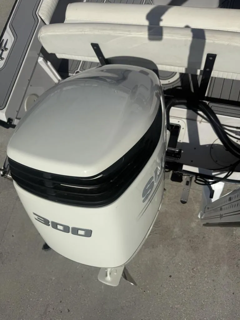 Slide: The Image of Outboard motor on a 1996 Boston Whaler 21 Outrage boat, featuring a 300 horsepower engine. - 24