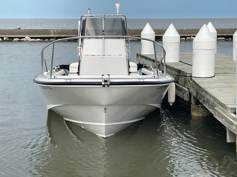 Slide: The Image of 1996 Boston Whaler 21 Outrage boat docked at a marina. - 5