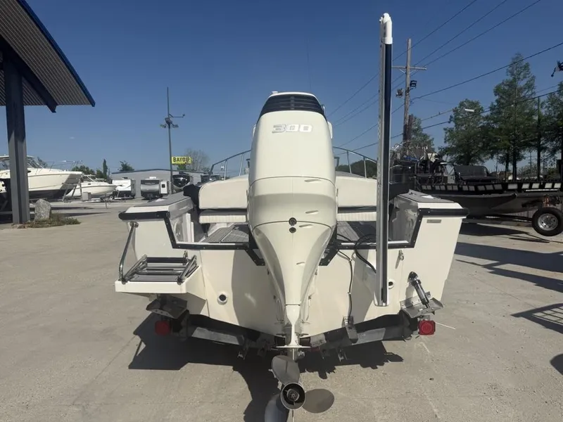 Slide: The Image of 1996 Boston Whaler 21 Outrage boat with powerful outboard motor, parked outdoors. - 8