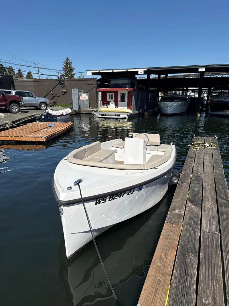 Slide: The Image of 2022 Rand Picnic boat docked at marina under clear blue sky. - 12
