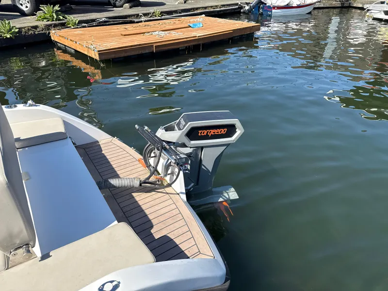 Slide: The Image of Electric motor on Rand Picnic boat, docked on calm water, 2022 model. - 3