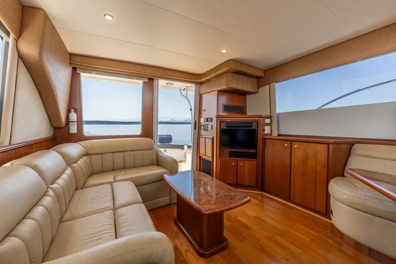 Slide: The Image of Luxurious interior of 2006 Silverton 42 Convertible yacht with leather seating and wood finishes. - 13