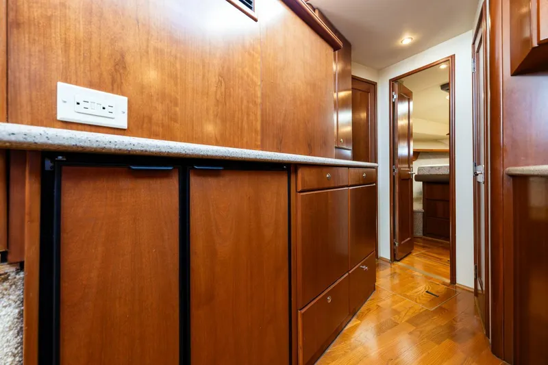 Slide: The Image of 2006 Silverton 42 Convertible yacht interior with wooden cabinetry and hallway view. - 18