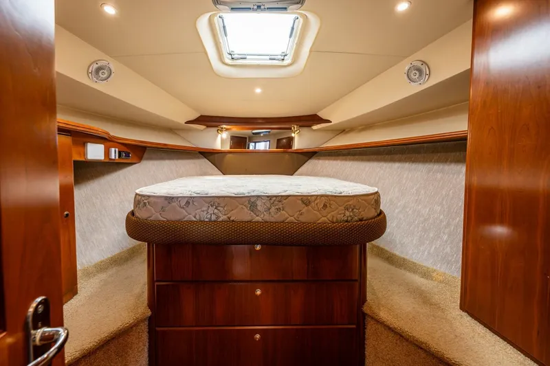 Slide: The Image of 2006 Silverton 42 Convertible yacht interior with cozy bedroom and skylight. - 19