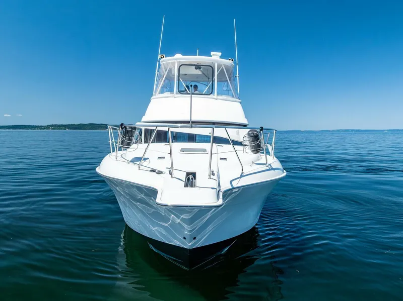 Slide: The Image of 2006 Silverton 42 Convertible yacht on calm blue water, front view. - 2
