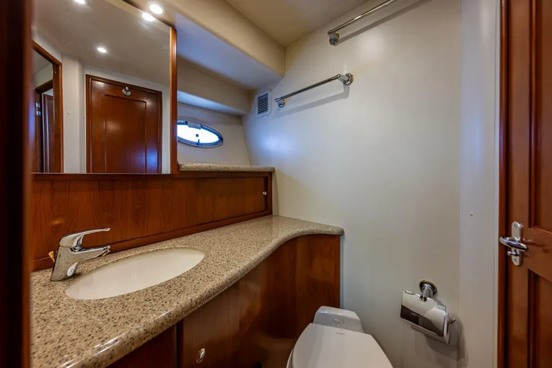 Slide: The Image of Luxurious bathroom in 2006 Silverton 42 Convertible yacht with granite countertop and wooden cabinetry. - 20