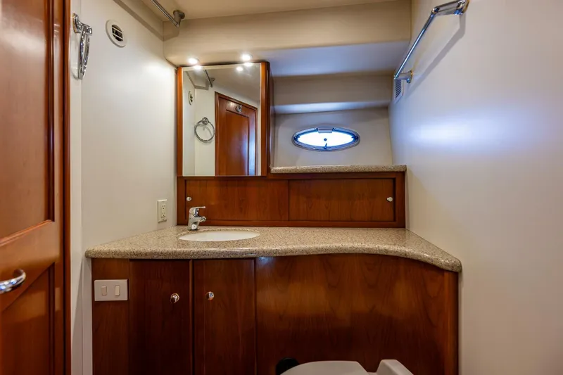 Slide: The Image of Luxurious bathroom interior of 2006 Silverton 42 Convertible yacht with wooden cabinetry. - 21