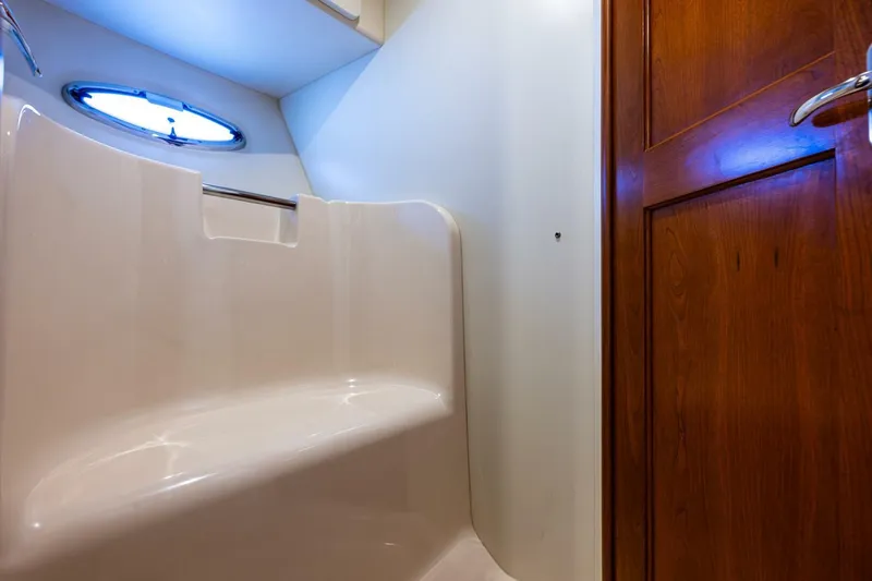Slide: The Image of Interior of 2006 Silverton 42 Convertible yacht, featuring a sleek bathroom design. - 22