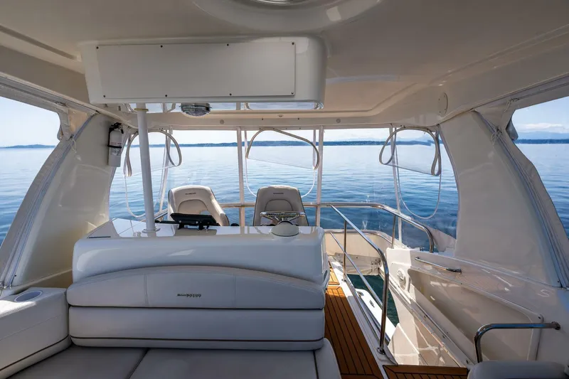 Slide: The Image of 2006 Silverton 42 Convertible yacht interior with seating, helm, and ocean view. - 25