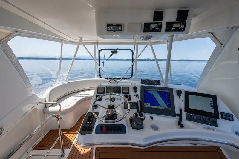 Slide: The Image of 2006 Silverton 42 Convertible yacht helm with navigation equipment and panoramic sea view. - 29