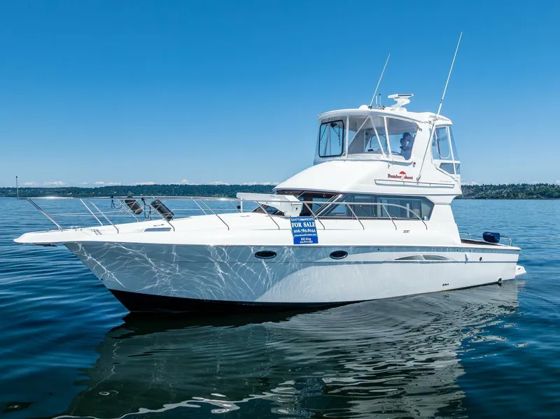 Slide: The Image of 2006 Silverton 42 Convertible yacht on calm water, clear blue sky. - 3