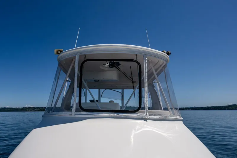 Slide: The Image of 2006 Silverton 42 Convertible boat on calm water under clear blue sky. - 30