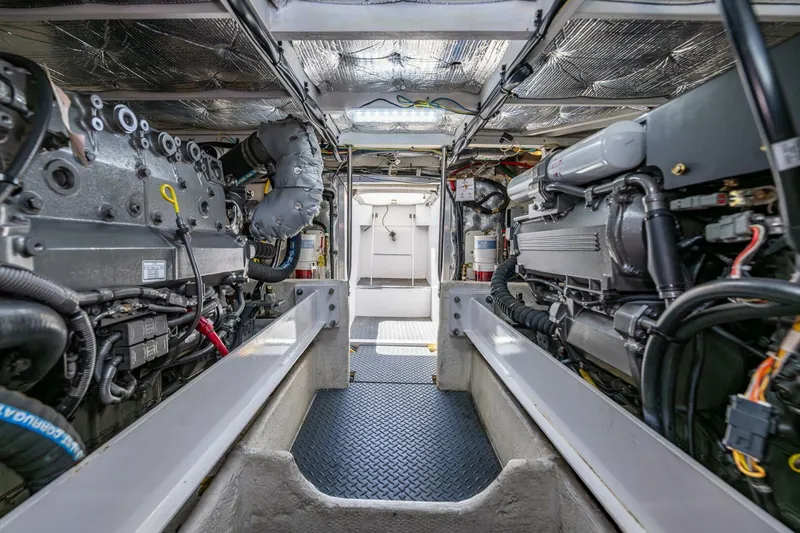 Slide: The Image of Engine room of 2006 Silverton 42 Convertible yacht, showcasing dual engines and mechanical systems. - 34