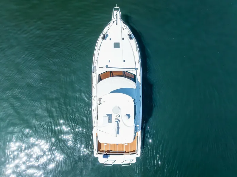 Slide: The Image of Aerial view of 2006 Silverton 42 Convertible yacht on calm water. - 39