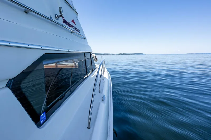 Slide: The Image of 2006 Silverton 42 Convertible yacht cruising on calm blue waters. - 44