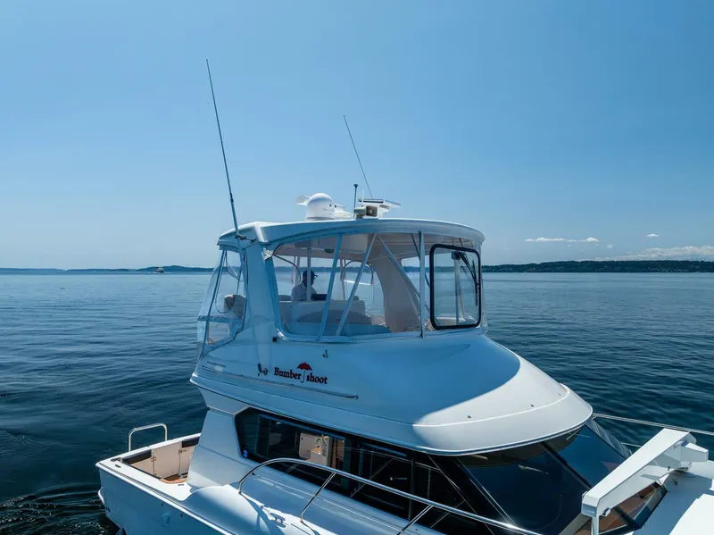 Slide: The Image of 2006 Silverton 42 Convertible yacht on calm blue water under clear sky. - 45