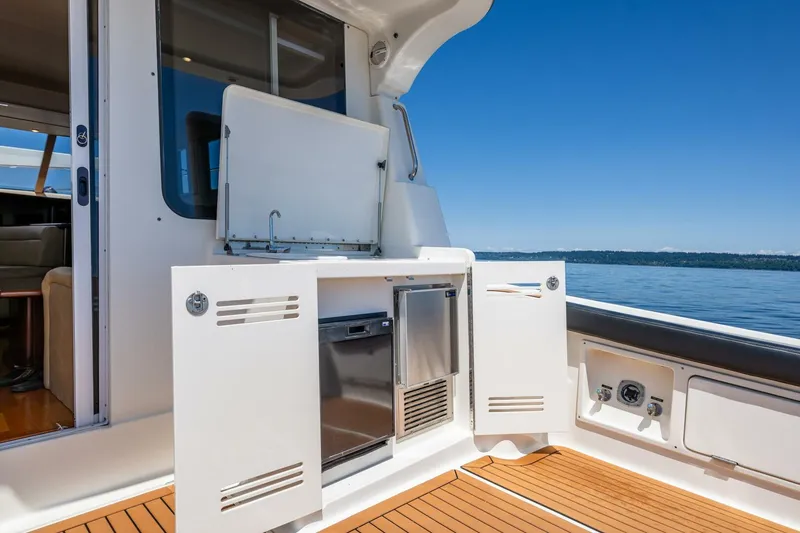 Slide: The Image of 2006 Silverton 42 Convertible yacht deck with open storage and ocean view. - 8