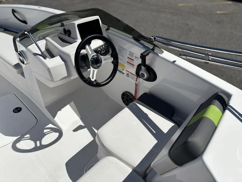 Slide: The Image of 2024 Tahoe T16 boat interior with steering wheel, seating, and dashboard controls. - 13