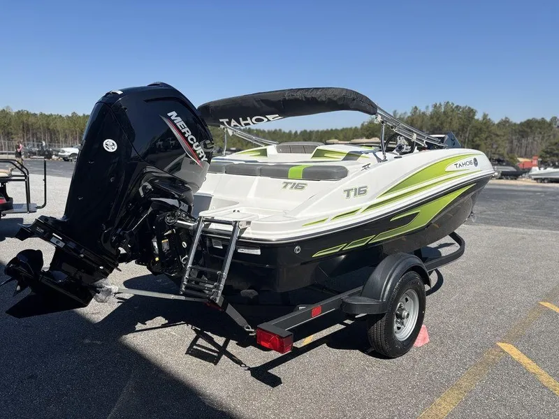 Slide: The Image of 2024 Tahoe T16 boat on trailer with Mercury outboard motor, parked outdoors. - 6